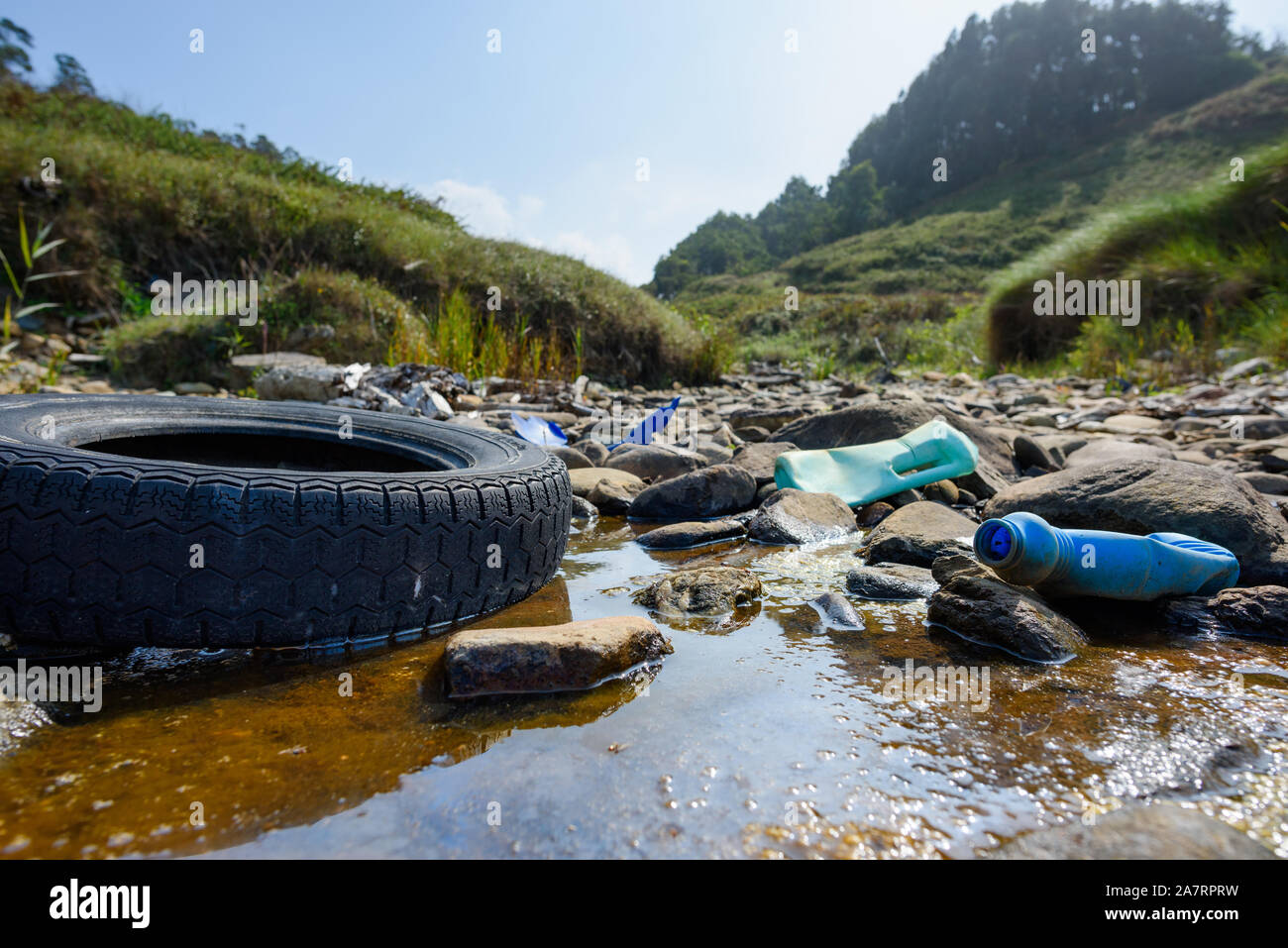 Earth plastics pollution global enviroment emergency. Old car tire in