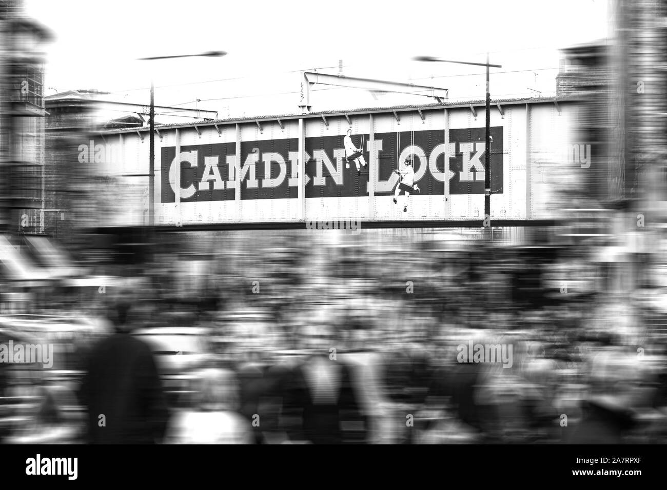 London, Centre of Camden Town: Iron bridge with Camden Lock logo and blurring of movement in the background Stock Photo