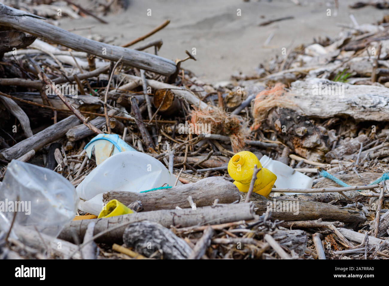 Plastic pollution in drift wood debris on ocean shore Stock Photo