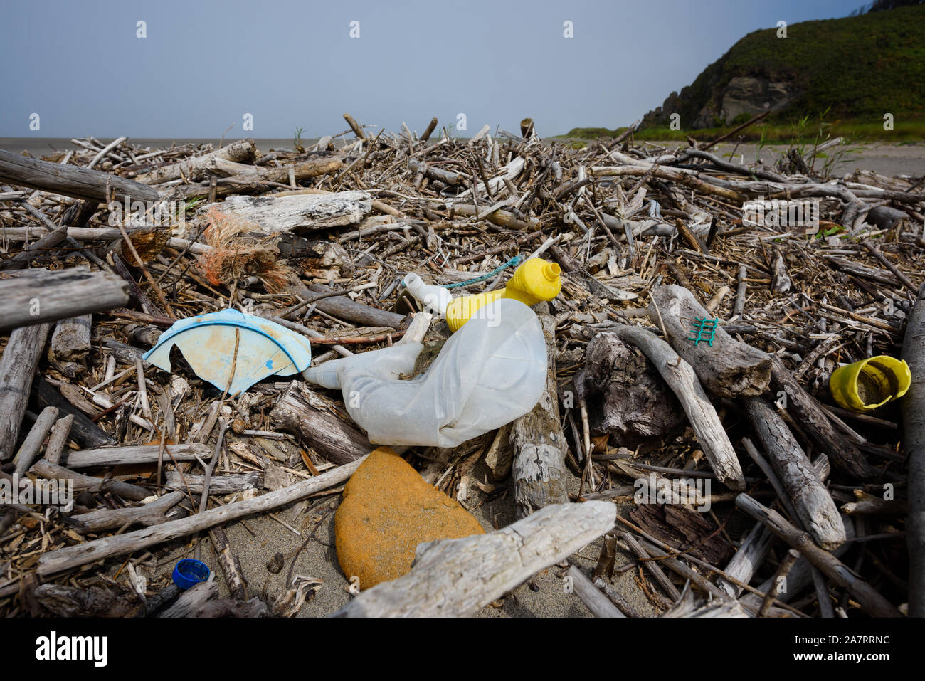 Plastic pollution nets bottles foam on ocean shore Stock Photo