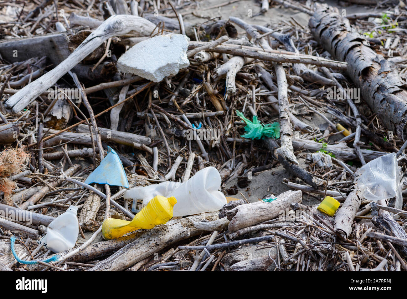 Plastic pollution trash waste in debris on ocean beach Stock Photo