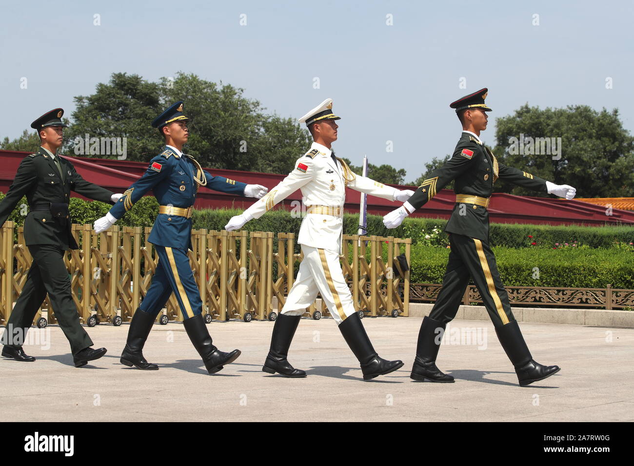 Two soldiers, a sailor and an airman patrol at the Tian'anmen Square to