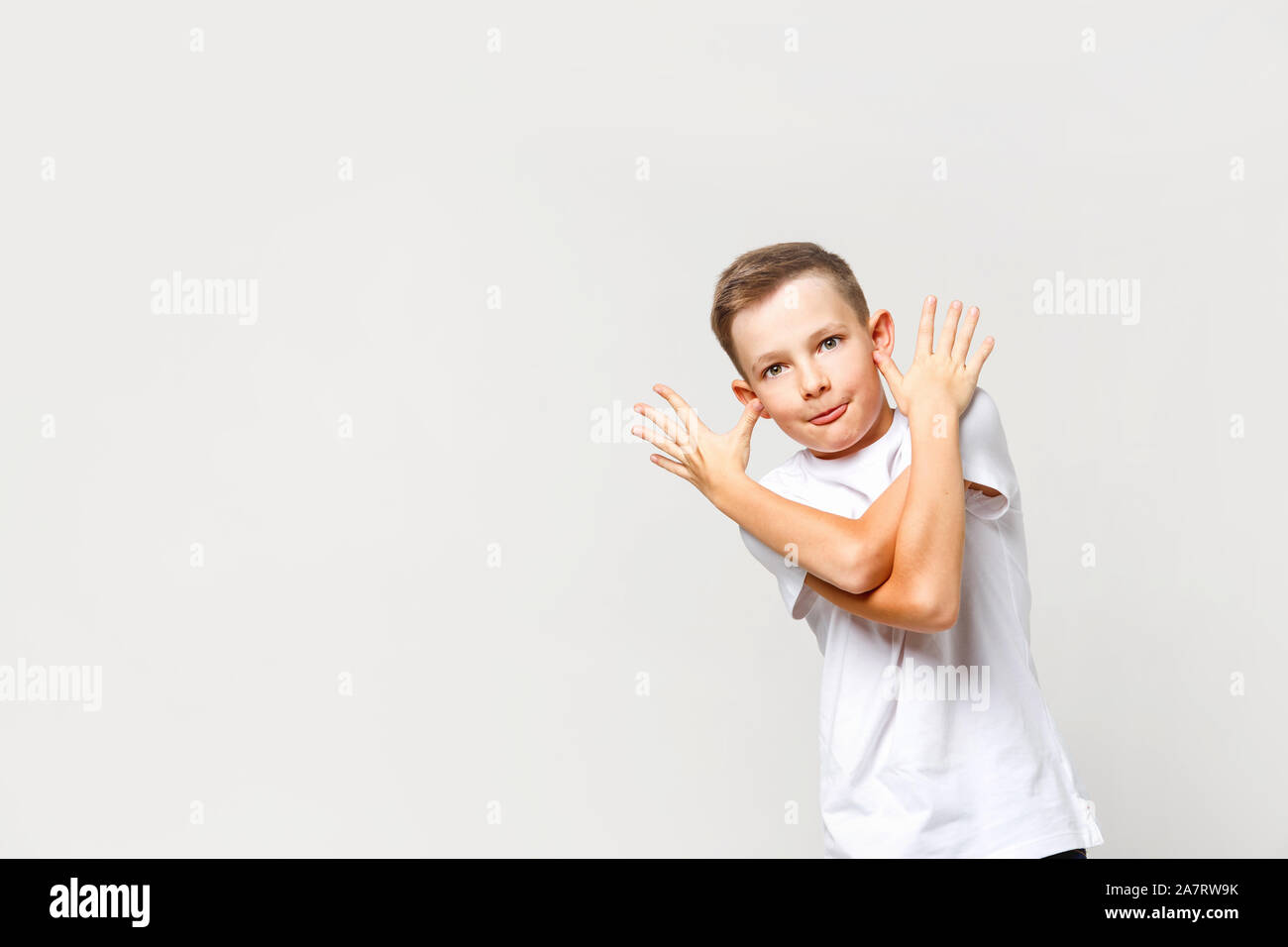 Carefree naughty caucasian boy grimaces. Portrait on an isolated background. Stock Photo