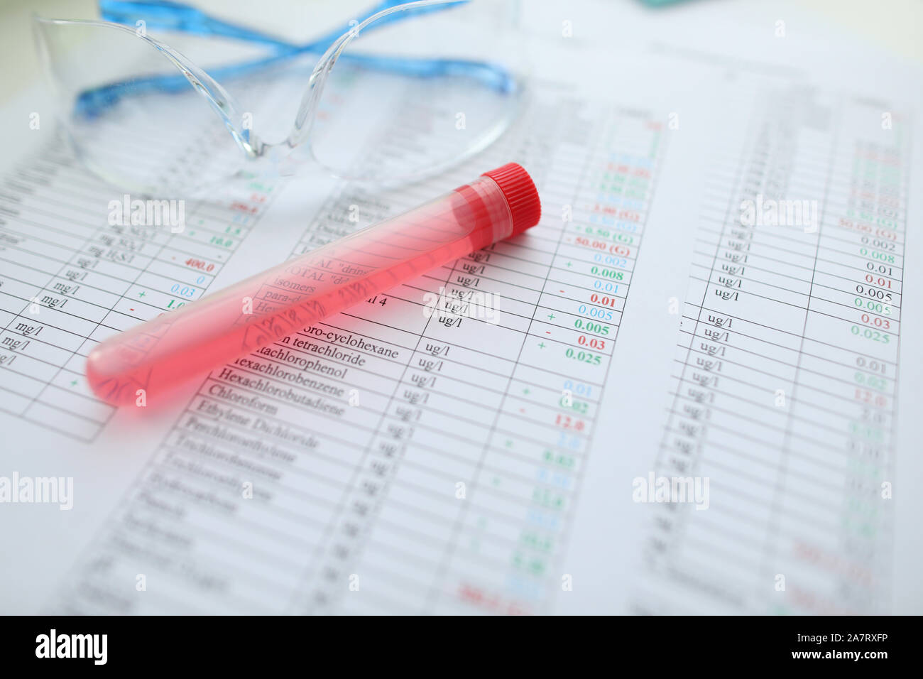 Testing tube with red liquid lying at chemical composition Stock Photo