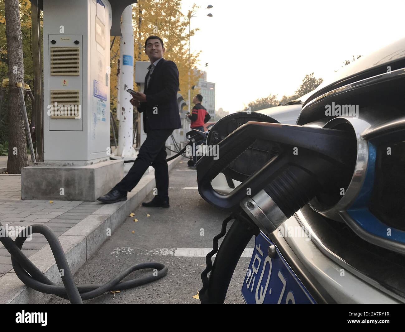 Beijing, China. 04th Nov, 2019. A Chinese man uses an electric car recharge station in Beijing on Monday, November 4, 2019. BYD, China's biggest maker of new energy vehicles, reported close to a 90 percent slump in quarterly net income as slowing demand in the world's largest car market continue to erode its bottom line. Photo by Stephen Shaver/UPI Credit: UPI/Alamy Live News Stock Photo