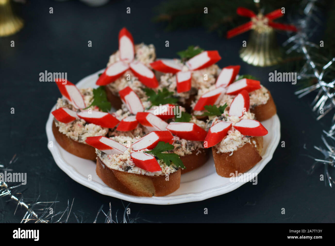 Festive sandwiches with crab sticks, cheese and champignons. Christmas ...