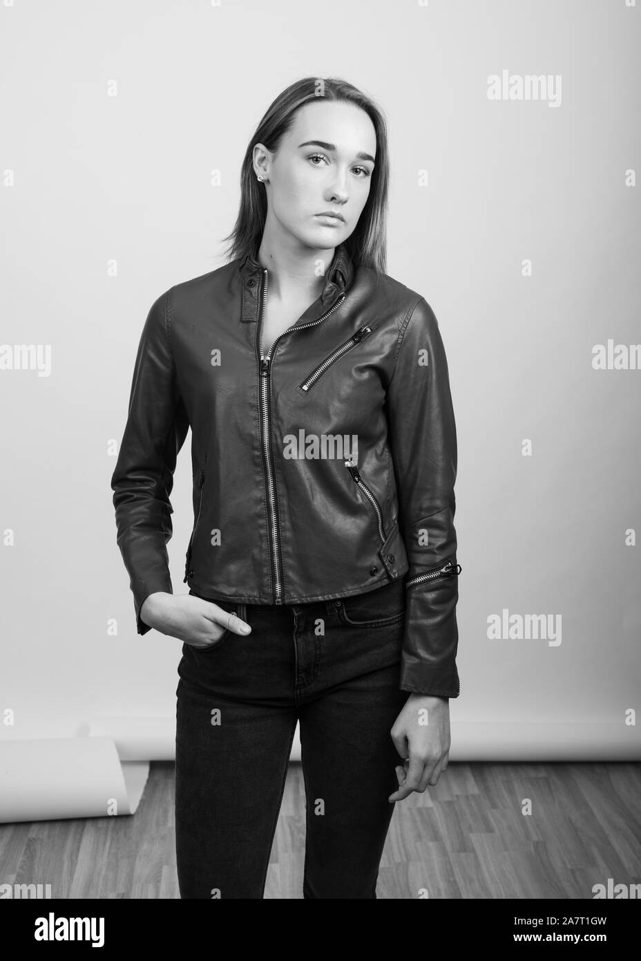 Black and white portrait of a young woman wearing a leather jacket Stock Photo