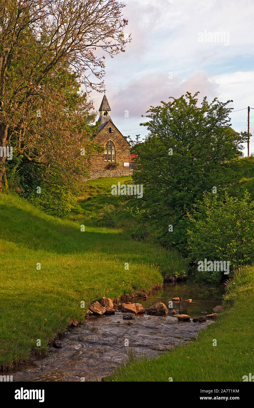 Hutton Beck meandering towards the Old School House inthe village of Hutton-le-Hole, North York Moors, Yorkshire, England, UK Stock Photo