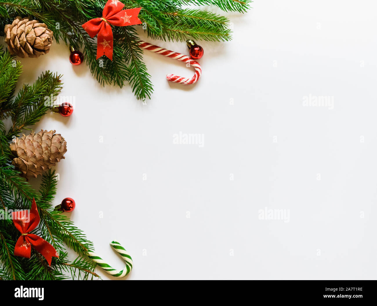top view, green branches of spruce together with New Year's toys and bows on a white background Stock Photo