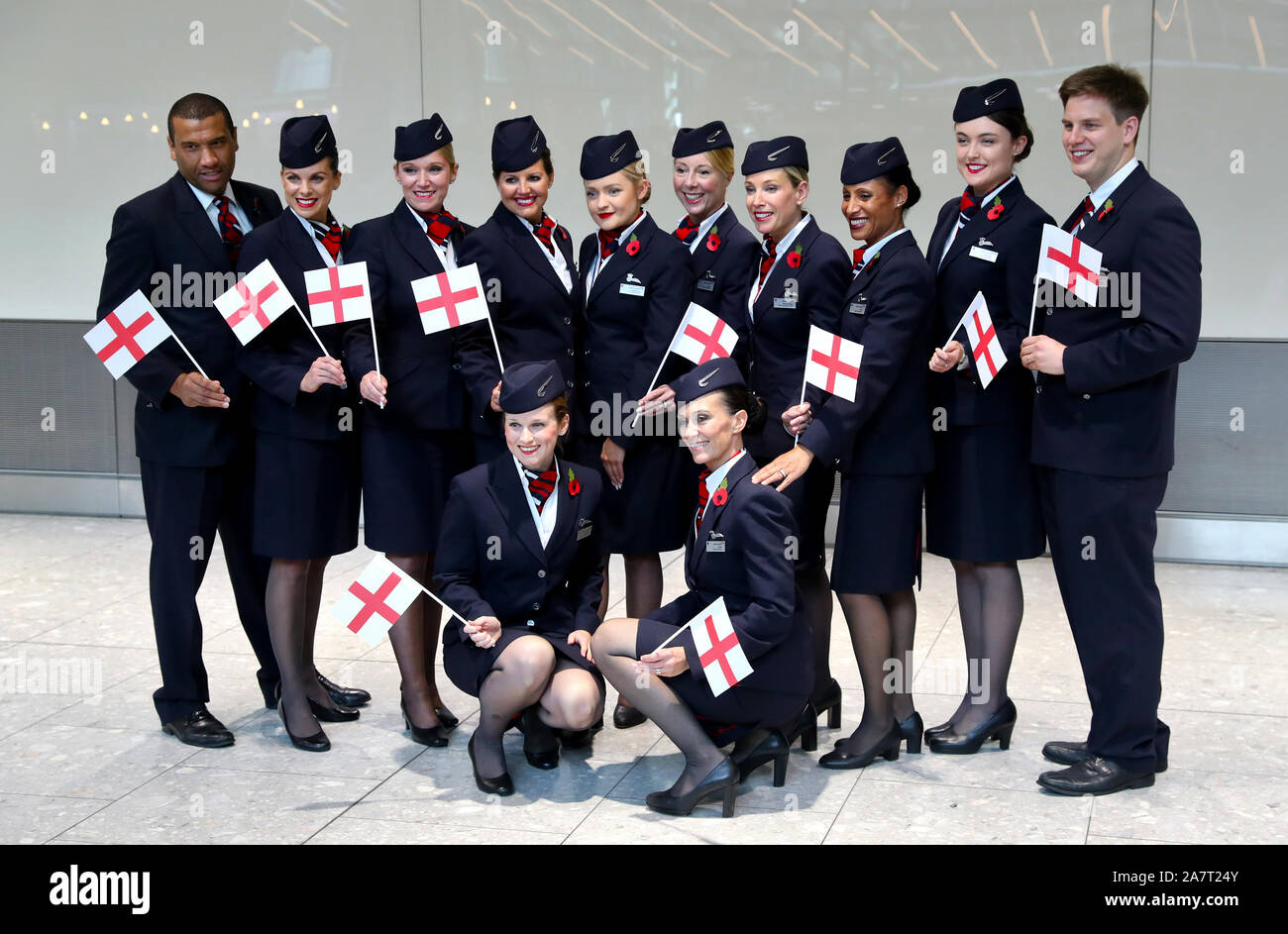 British Airways staff wait with England flags as the team return to ...