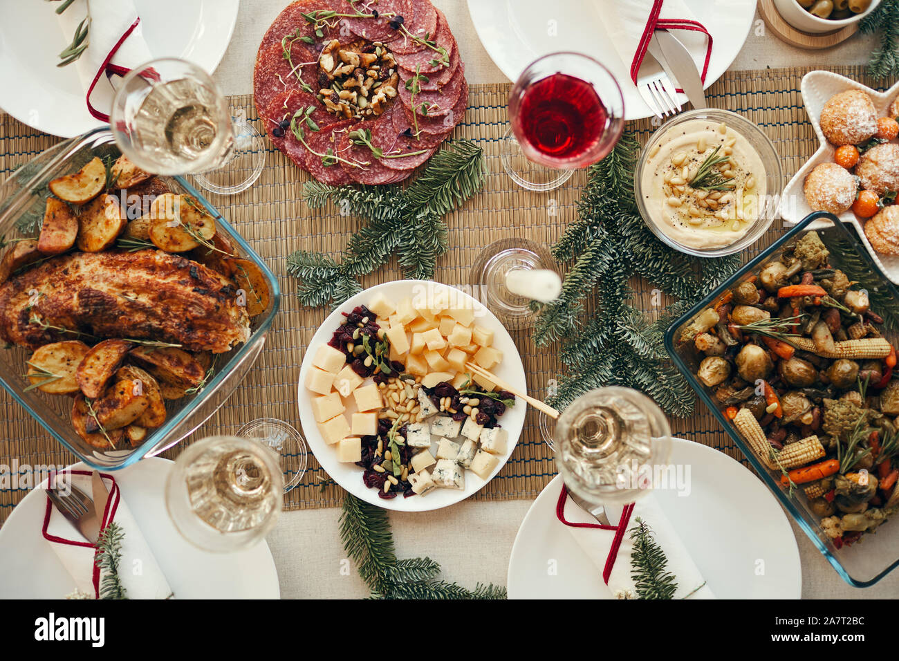 Top view background of rustic Christmas table with delicious homemade food decorated with fir branches, copy space Stock Photo