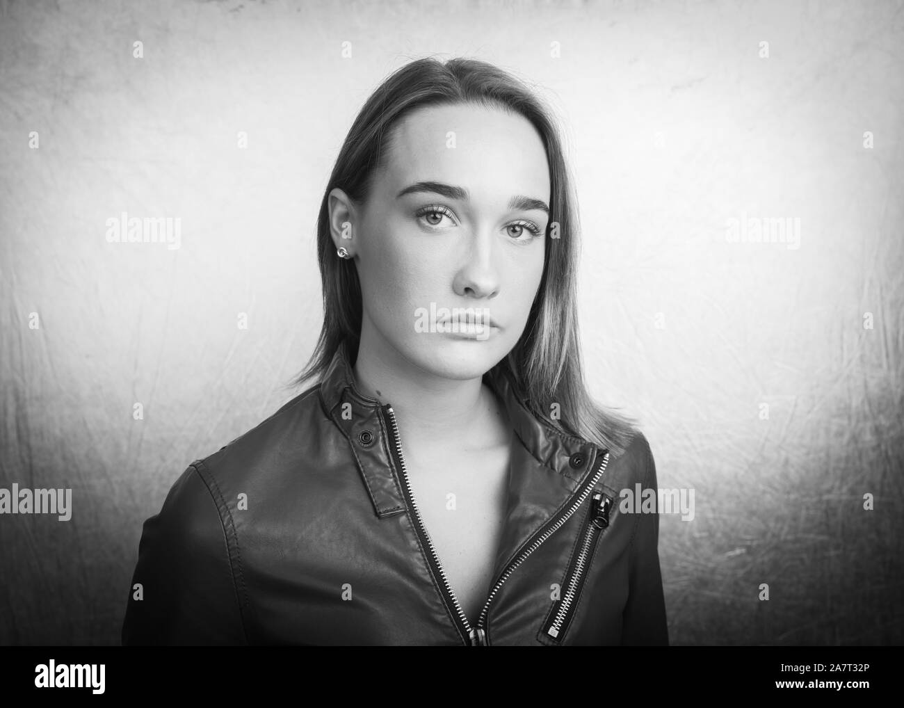 Grayscale portrait of a young woman wearing a leather jacket Stock Photo