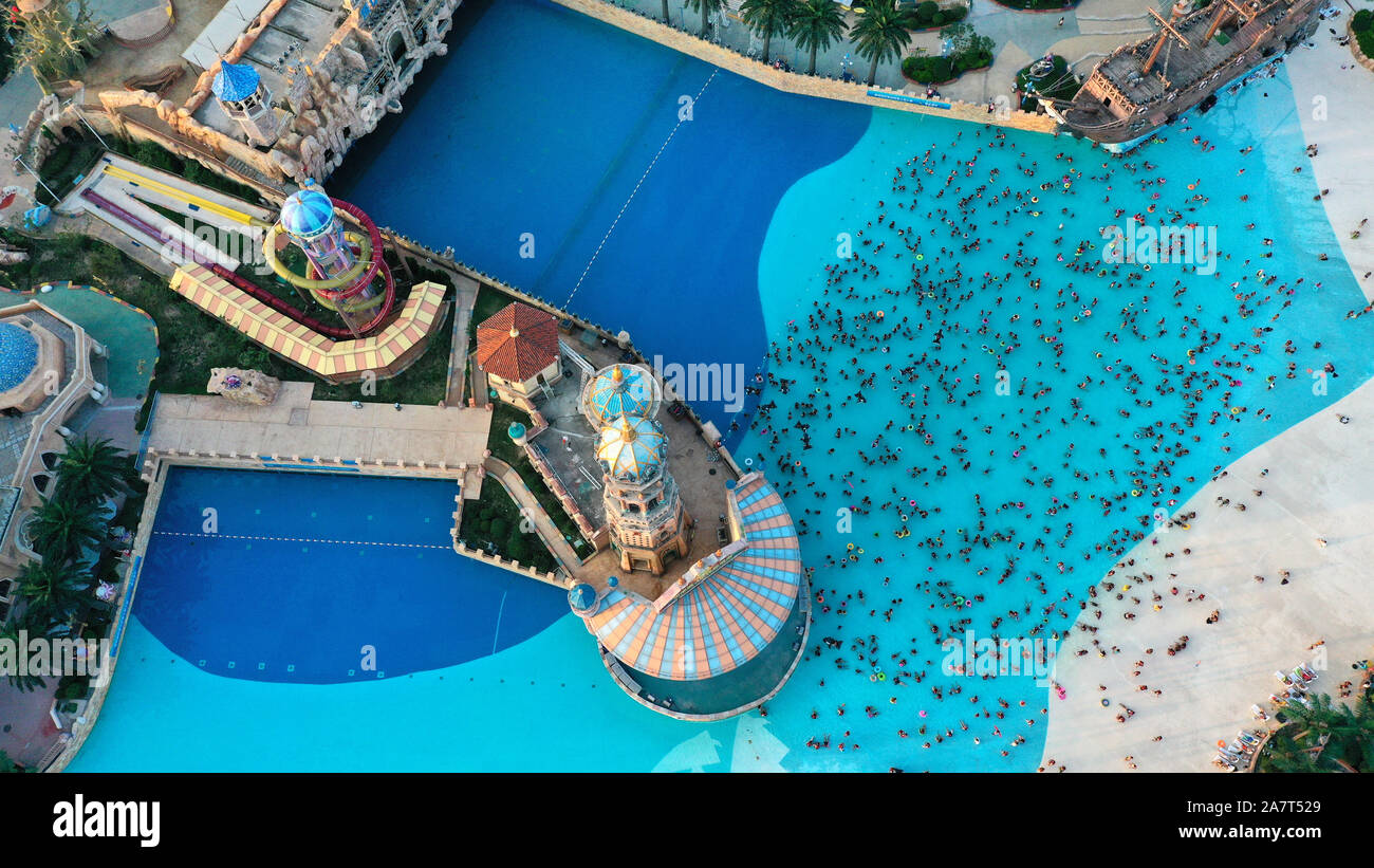 Tourists overwhelm a swimming pool at an amusement park on the traditional Chinese festival Qixi Festival, also known as the Chinese Valentine's Day, Stock Photo