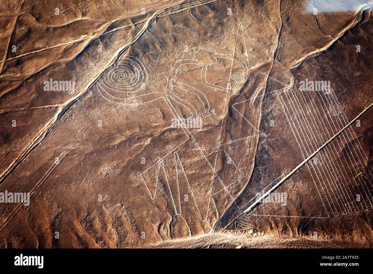 Flight over Nazca Desert.The Nazca Lines are a group of very large geoglyphs formed by depressions or shallow incisions made in the soil of desert. Stock Photo