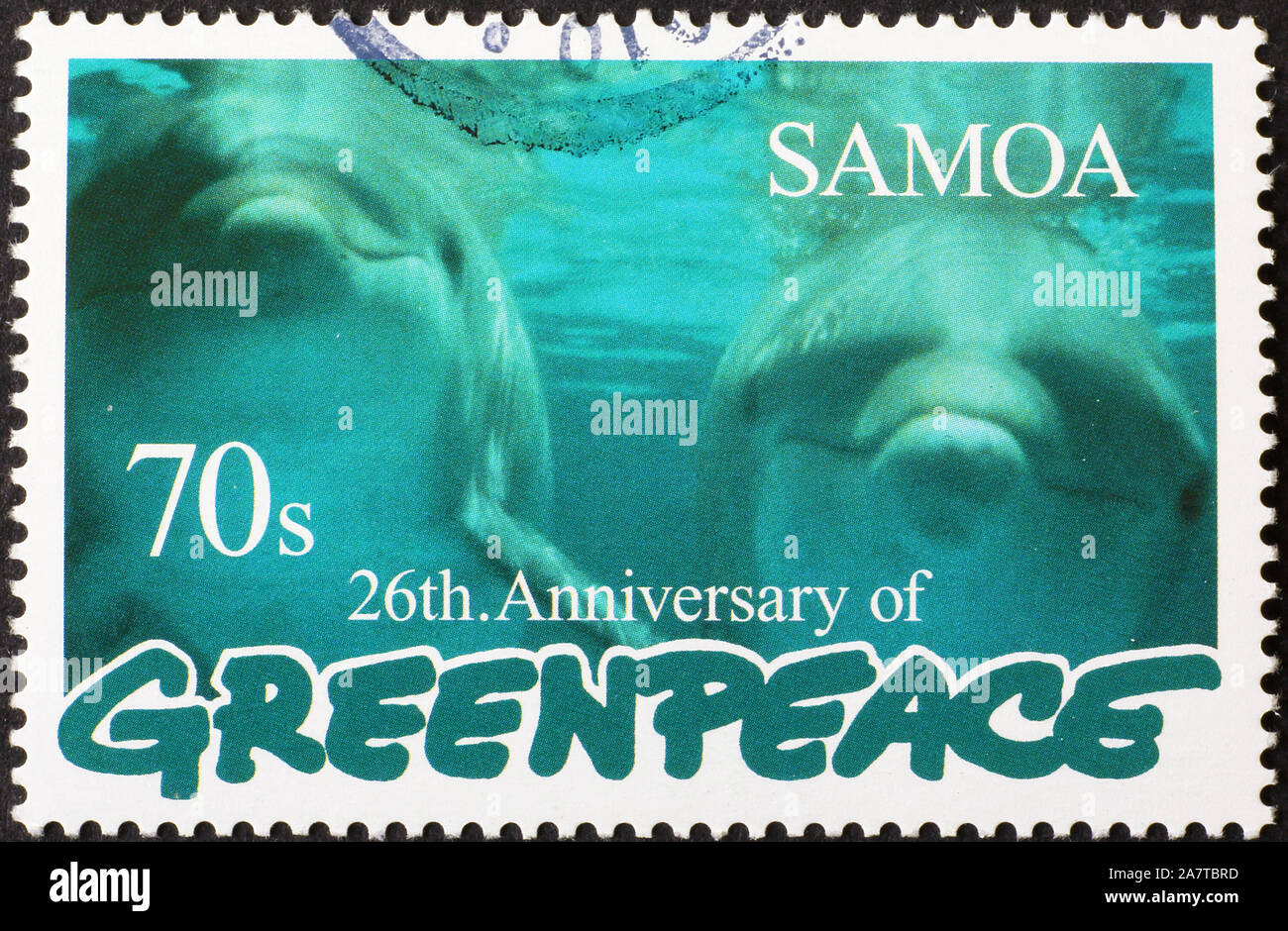 Two dolphins looking at you on Greenpeace postage stamp Stock Photo