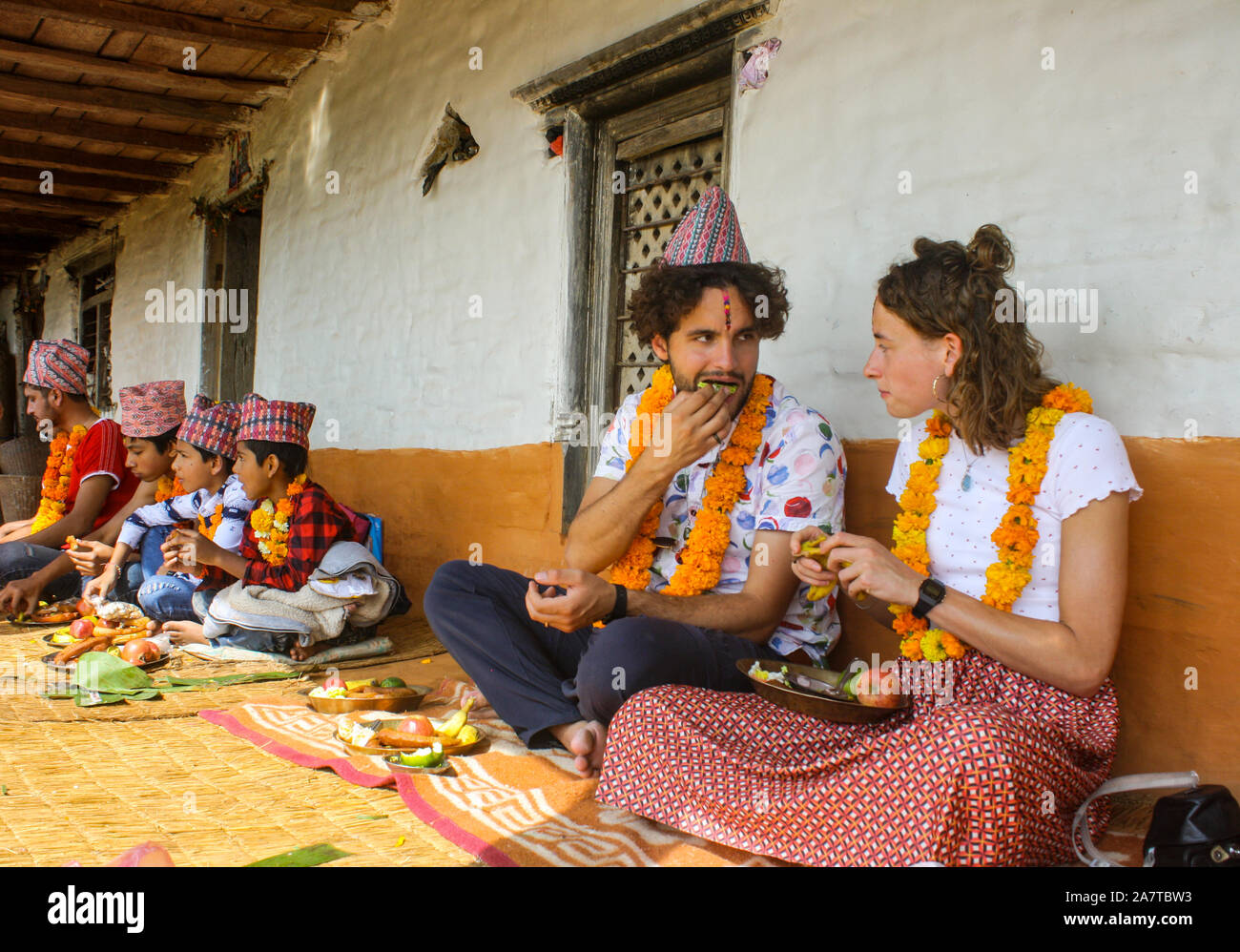 Foreigners celebrating Tihar / Bhai Tika Festival along with other Nepalese in Pokhara, Nepal. Stock Photo