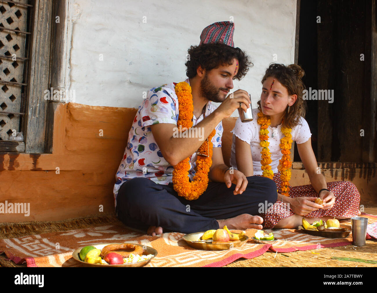 Foreigners celebrating Tihar / Bhai Tika Festival along with other Nepalese in Pokhara, Nepal. Stock Photo