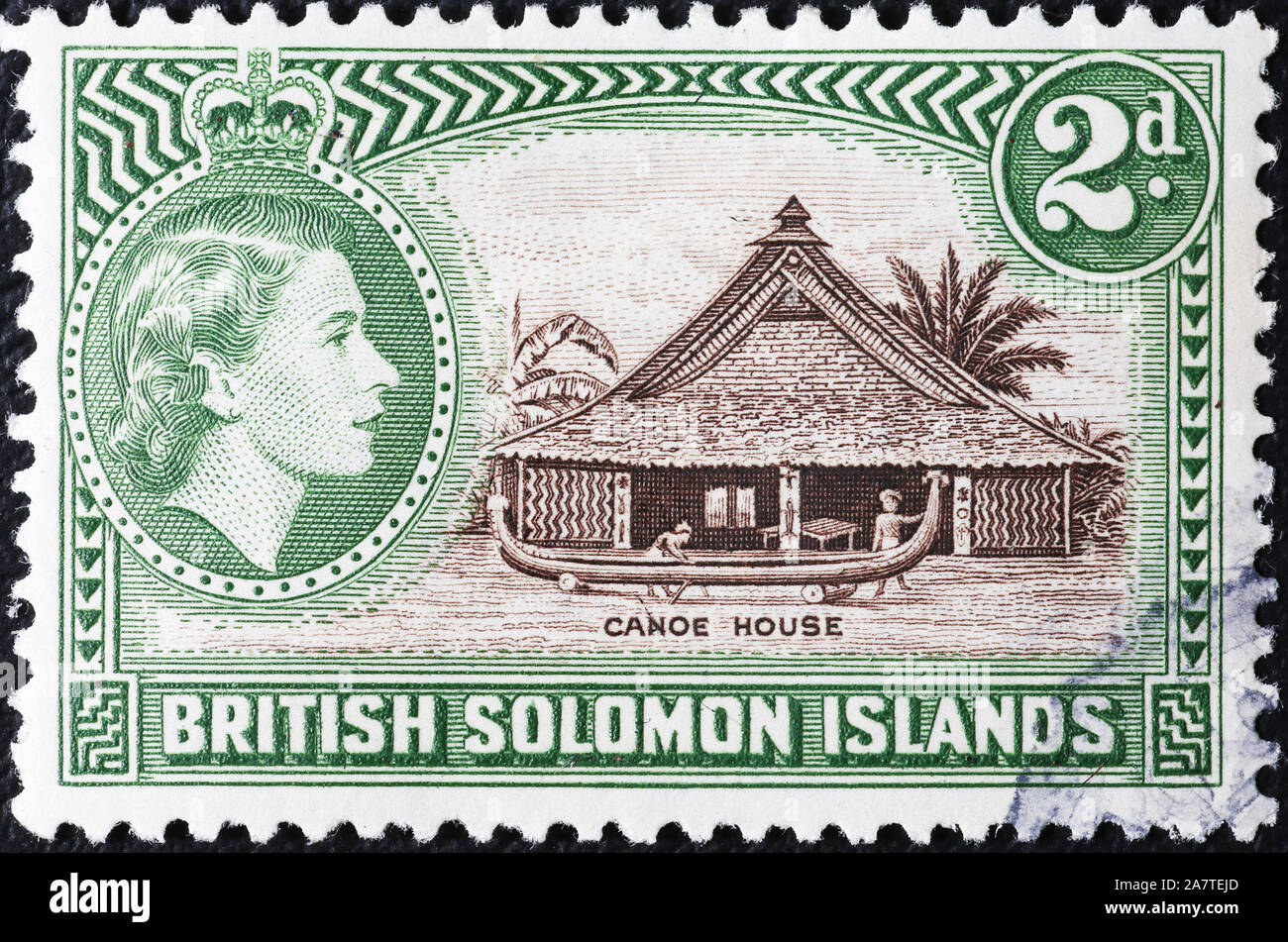 Building a canoe on old stamp of Solomon islands Stock Photo