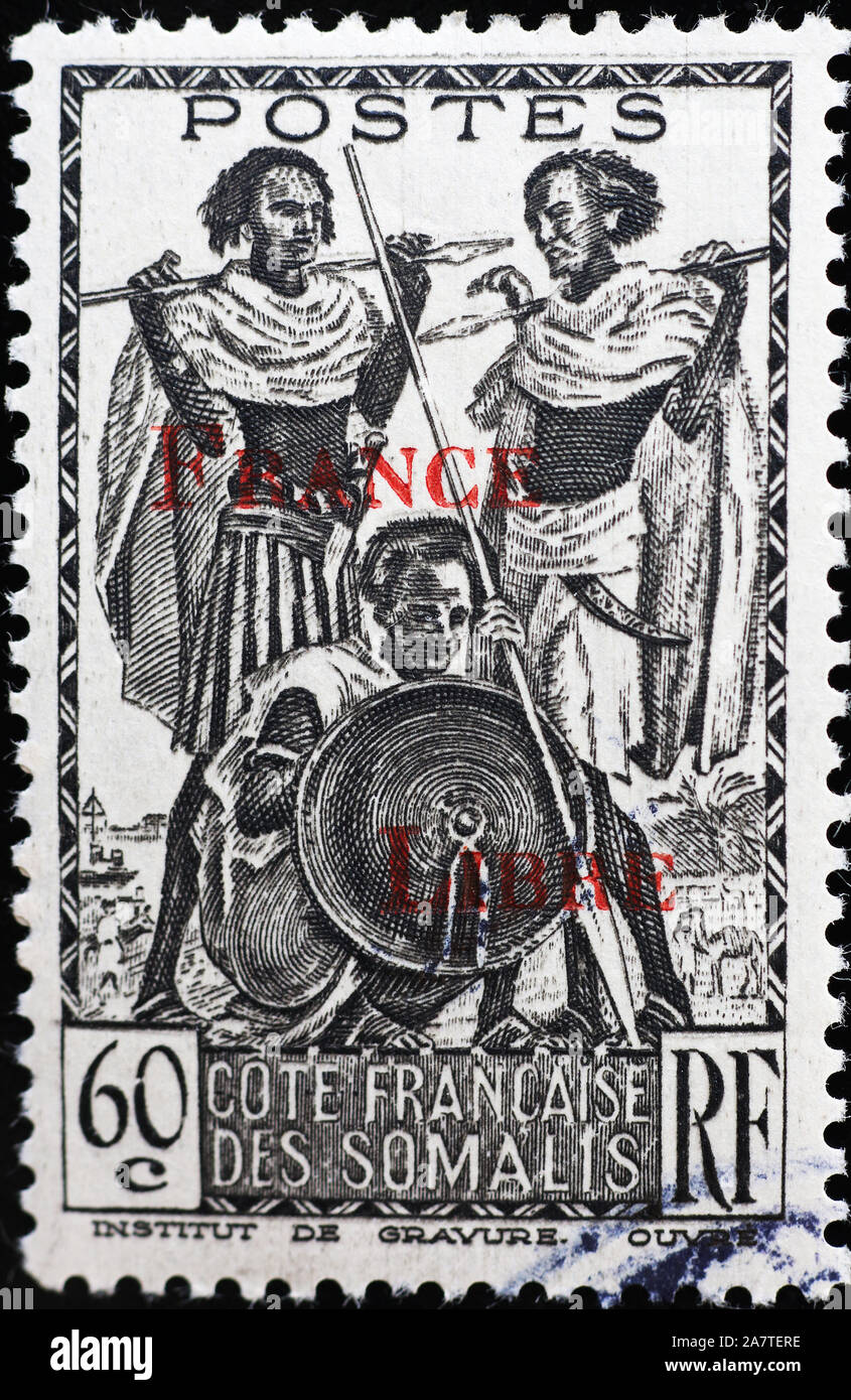 Three somali warriors on vintage postage stamp Stock Photo