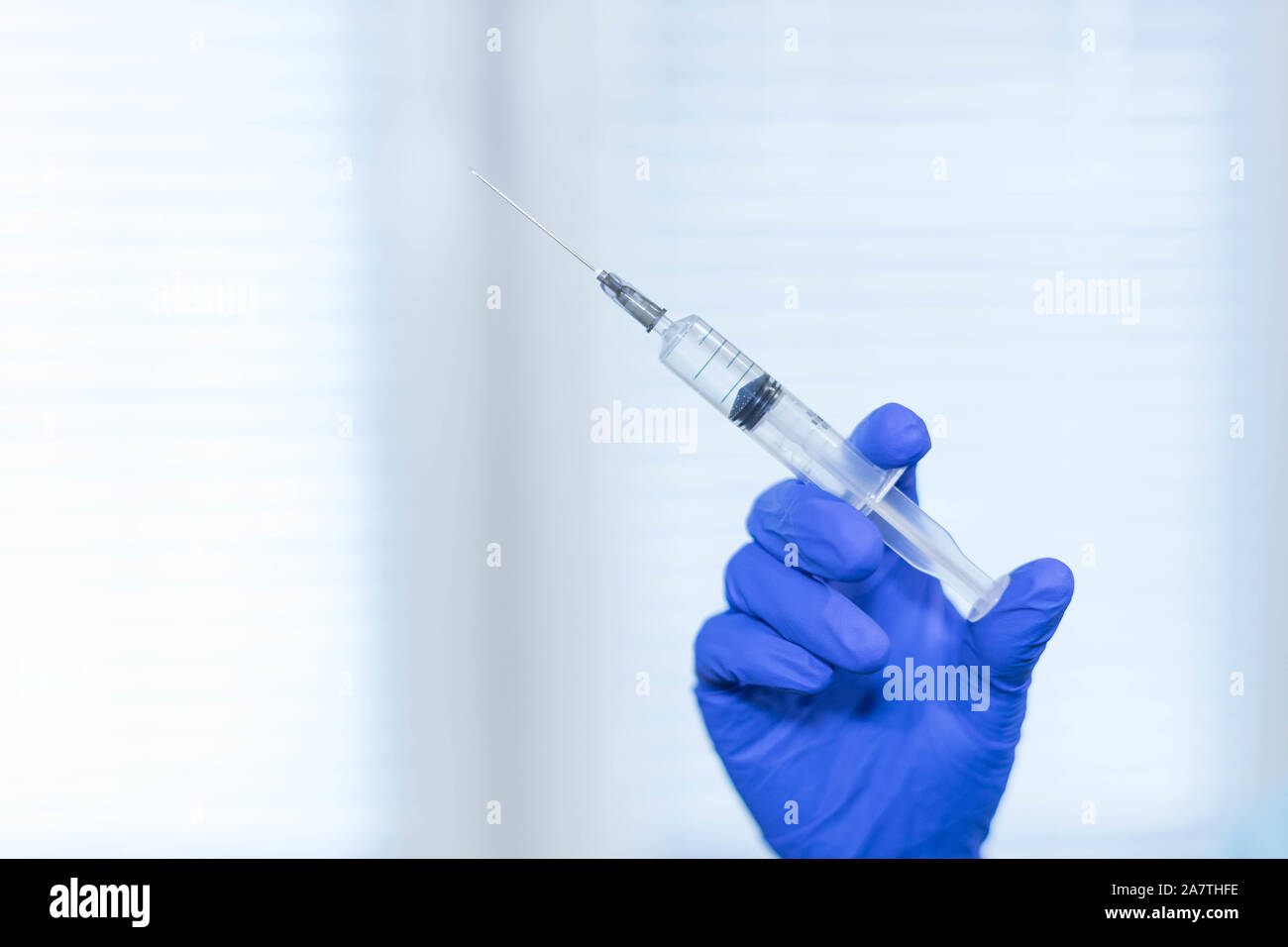 Medical background doctor's hand in a blue medical glove holds a ...