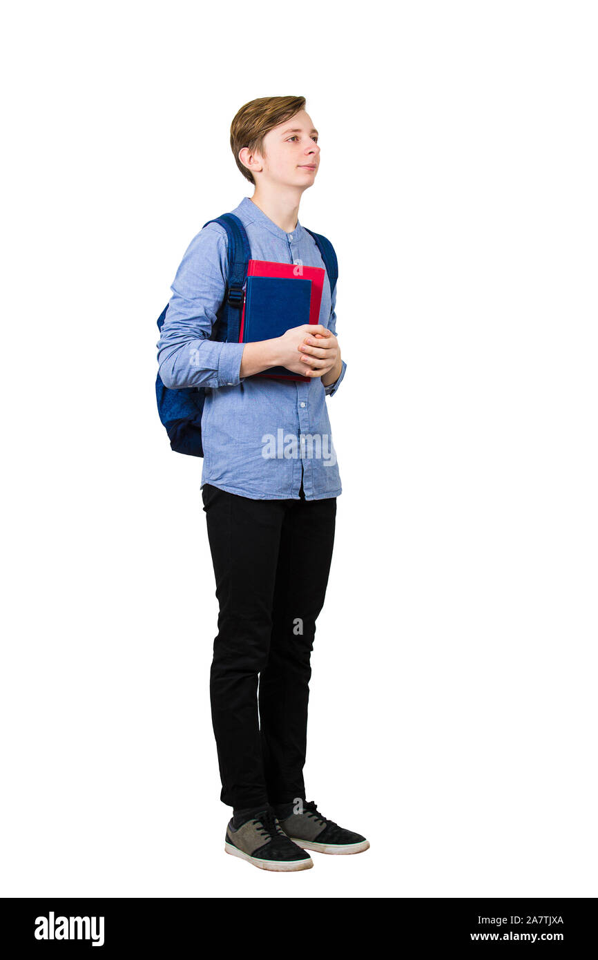 Full length portrait of student boy holding two books to chest and ...
