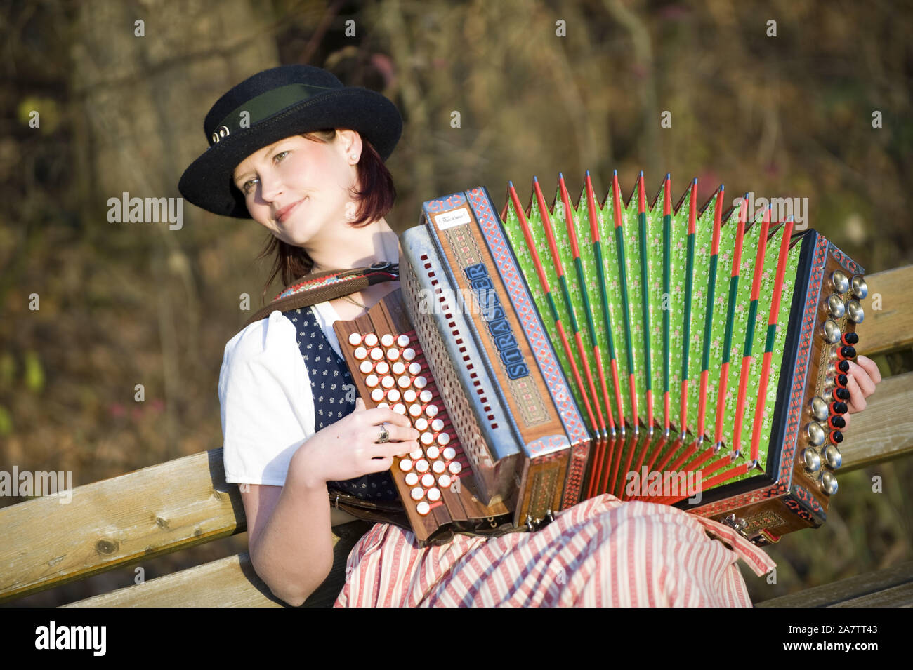 Junge Frau in Tracht mit steirischer Harmonika, Akkordeon, MR: Yes Stock Photo