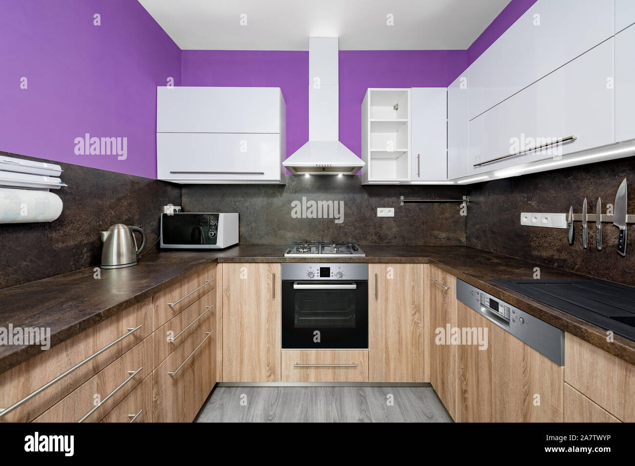 Modern kitchens combined with white and purple color and oak wood. Stock Photo