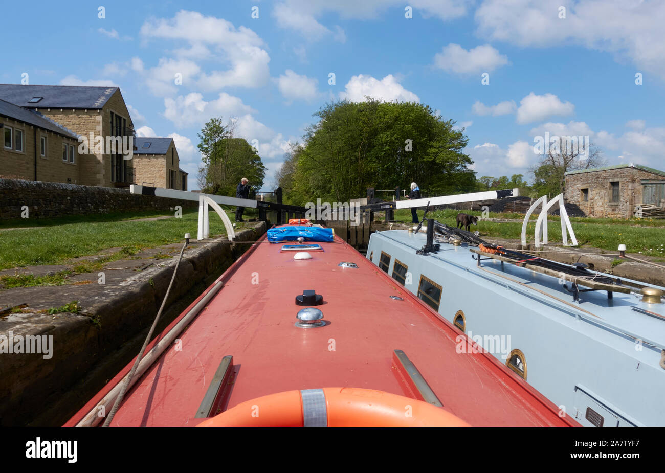 Two narrowboats in a lock on the Leeds & Liverpool Canal at Gargrave, North Yorkshire, UK. Stock Photo