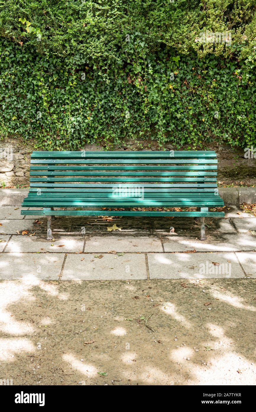 Green Wooden Bench With A Decorative Ornate Metal Legs And