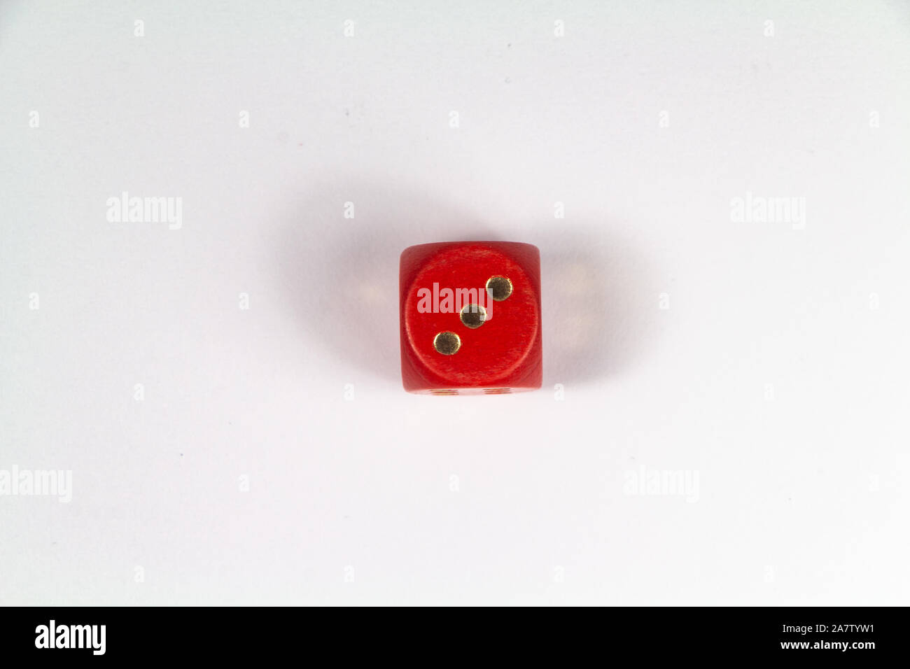 Red dice on number three on white background Stock Photo