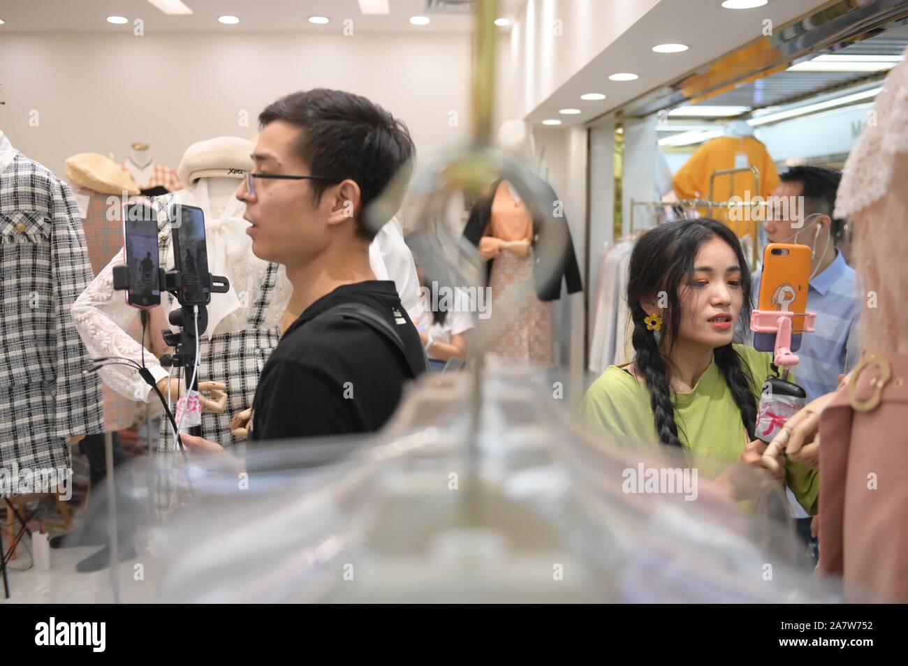 Online celebrities live-stream at the wholesale market in Guangzhou city, south China's Guangdong province, 29 August 2019.   Live-streaming at wholes Stock Photo