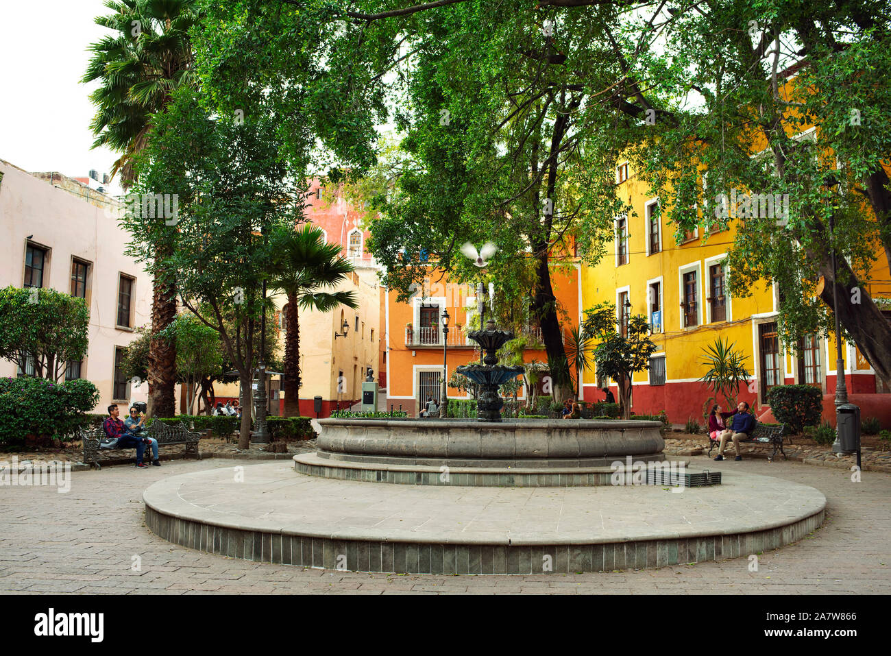 Locals taking a break around the fountain in Parque Reforma (Reform Park). Guanajuato, Mexico Stock Photo