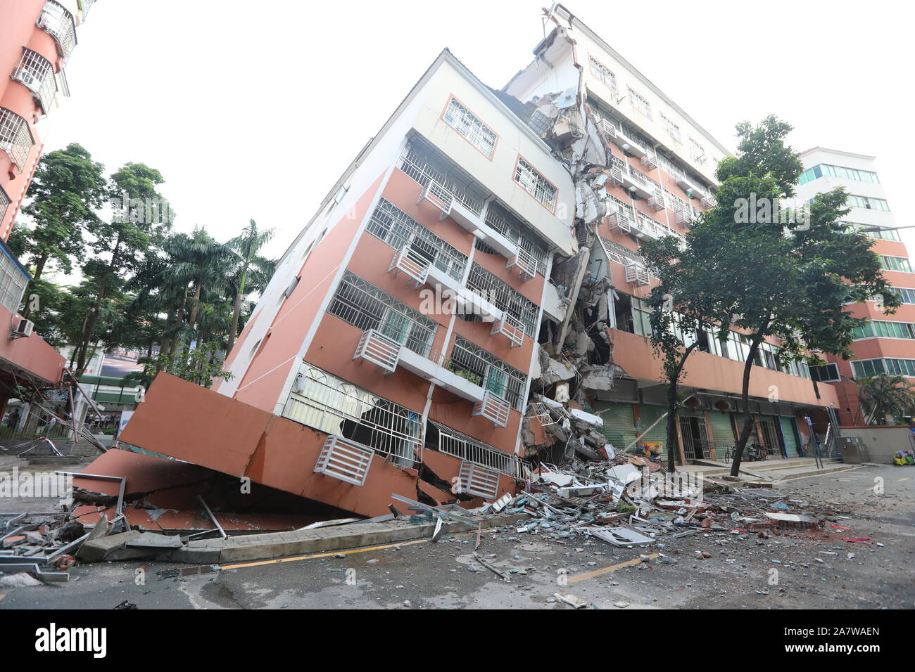 A view of an apartment building tilting and collapsing in Shenzhen city