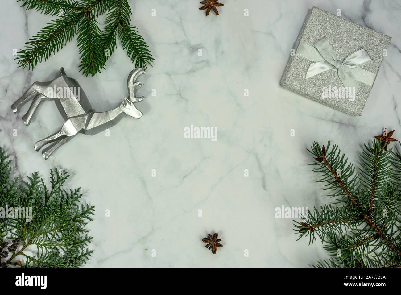 Christmas frame background on marbel with silver decoration and gift box . Stock Photo