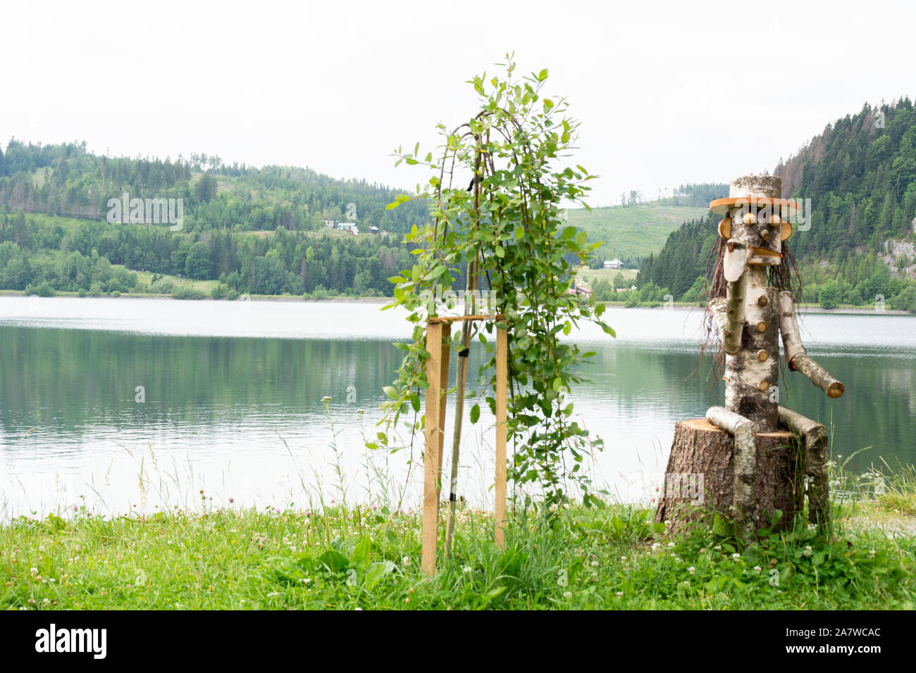 Dedinky, Roznava, Kosice region / Slovakia -  statue of a character smoking a pipe on a lake Stock Photo