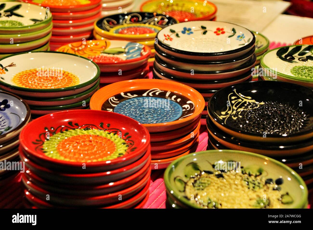 https://c8.alamy.com/comp/2A7WCGG/beautiful-and-colorful-ceramic-plates-for-sale-at-a-medieval-market-stall-2A7WCGG.jpg