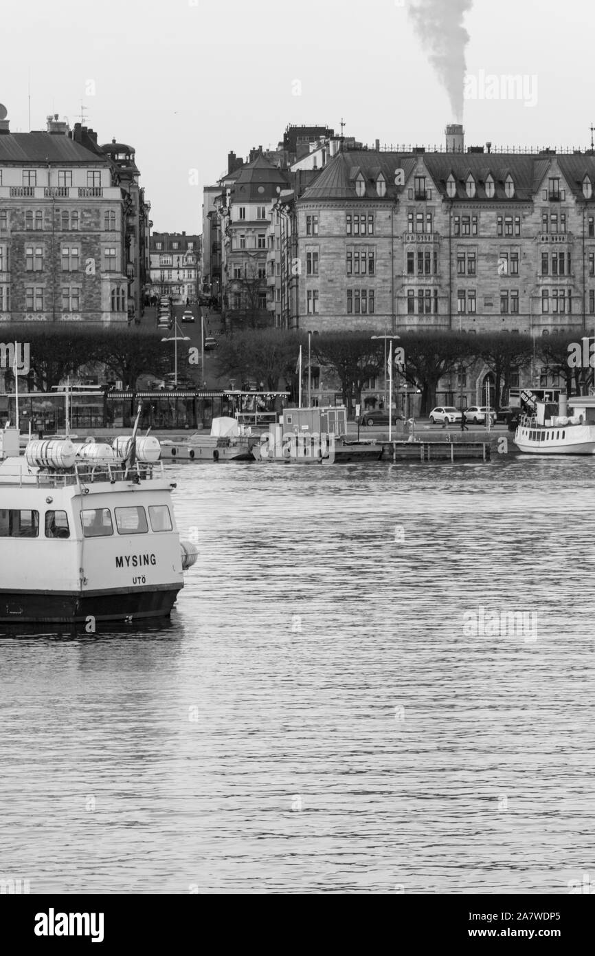 black and white image of Downtown Stockholm across the water with boats navigating. Sweden 2019 Stock Photo