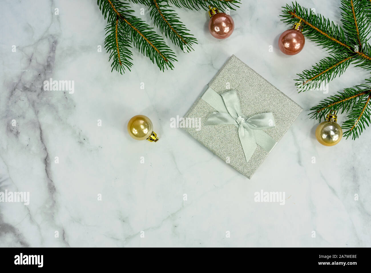 Christmas frame background on marbel with silver decoration ornaments and gift box . Stock Photo