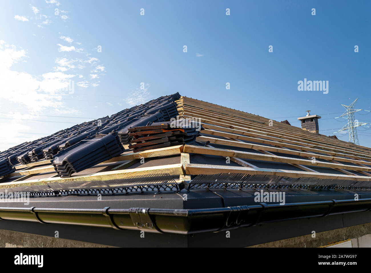 Roof ceramic tile arranged in packets on the roof on roof battens