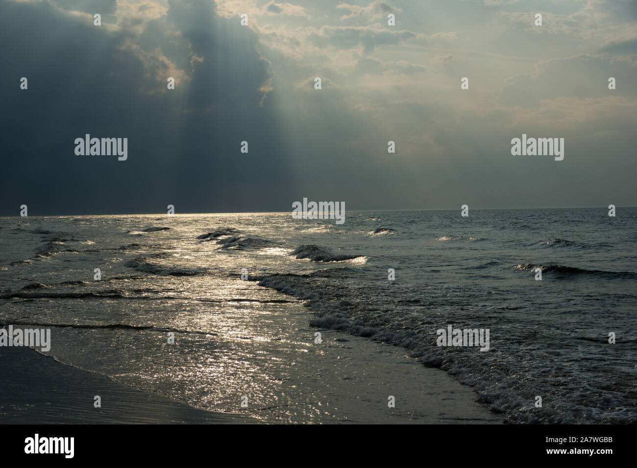 sun flares on a sea surface during sunset Stock Photo - Alamy