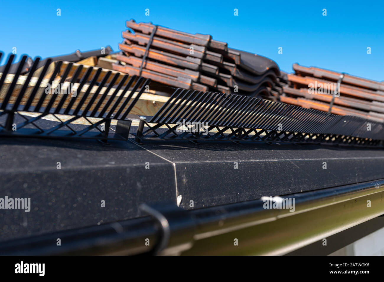 Roof ceramic tile arranged in packets on the roof on roof battens