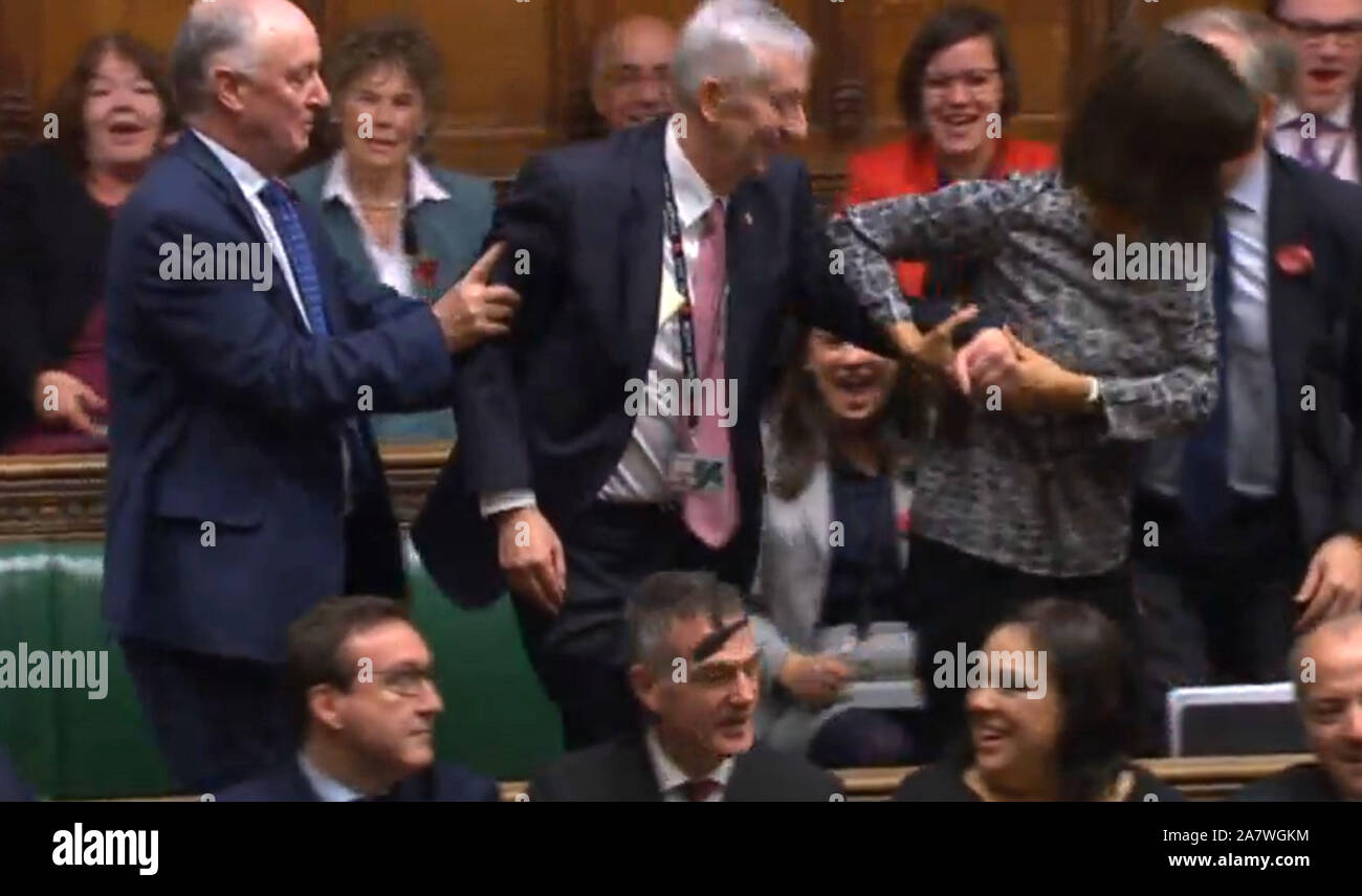 Sir Lindsay Hoyle (centre) is dragged to the speaker's chair after