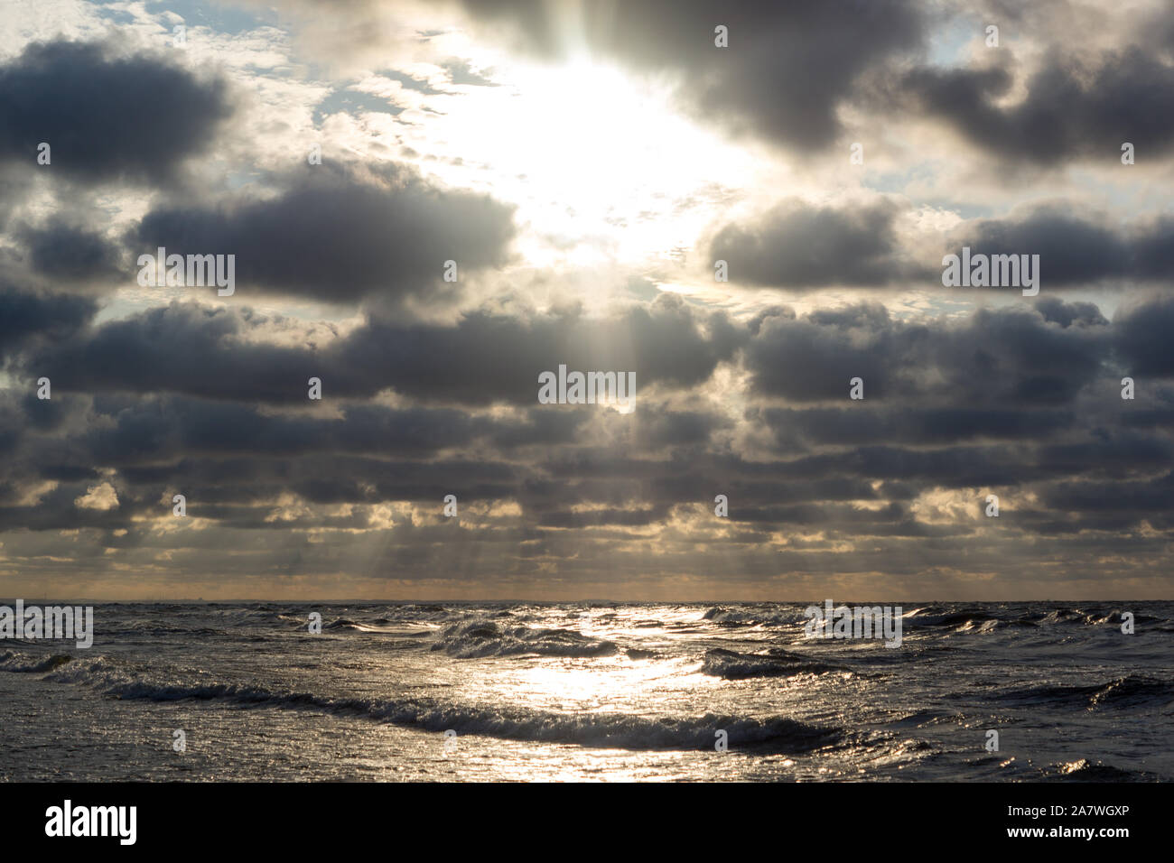 sun flares on a sea surface during sunset Stock Photo - Alamy