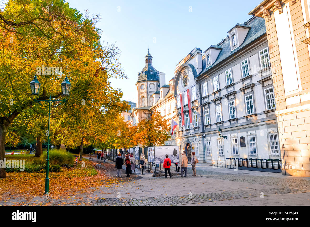 Pilsen, Czechia - Oct 28, 2019: Smetanovy sady in Plzen, Czech Republic. Outside exhibition in front of the library building. People on the streets. Fall trees. Old town of the historical city. Stock Photo