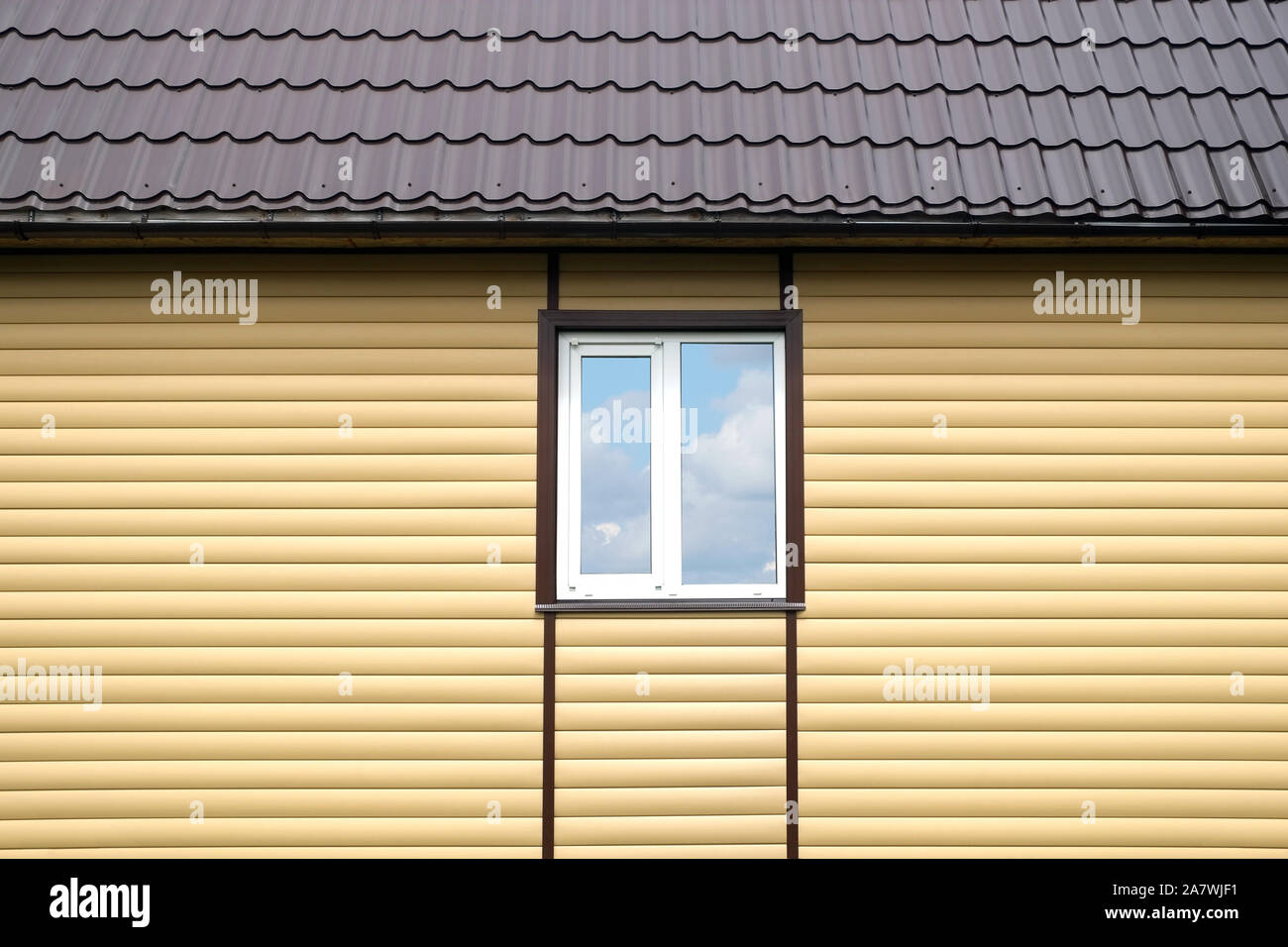 Building metal roof and wall finished with beige siding panels with