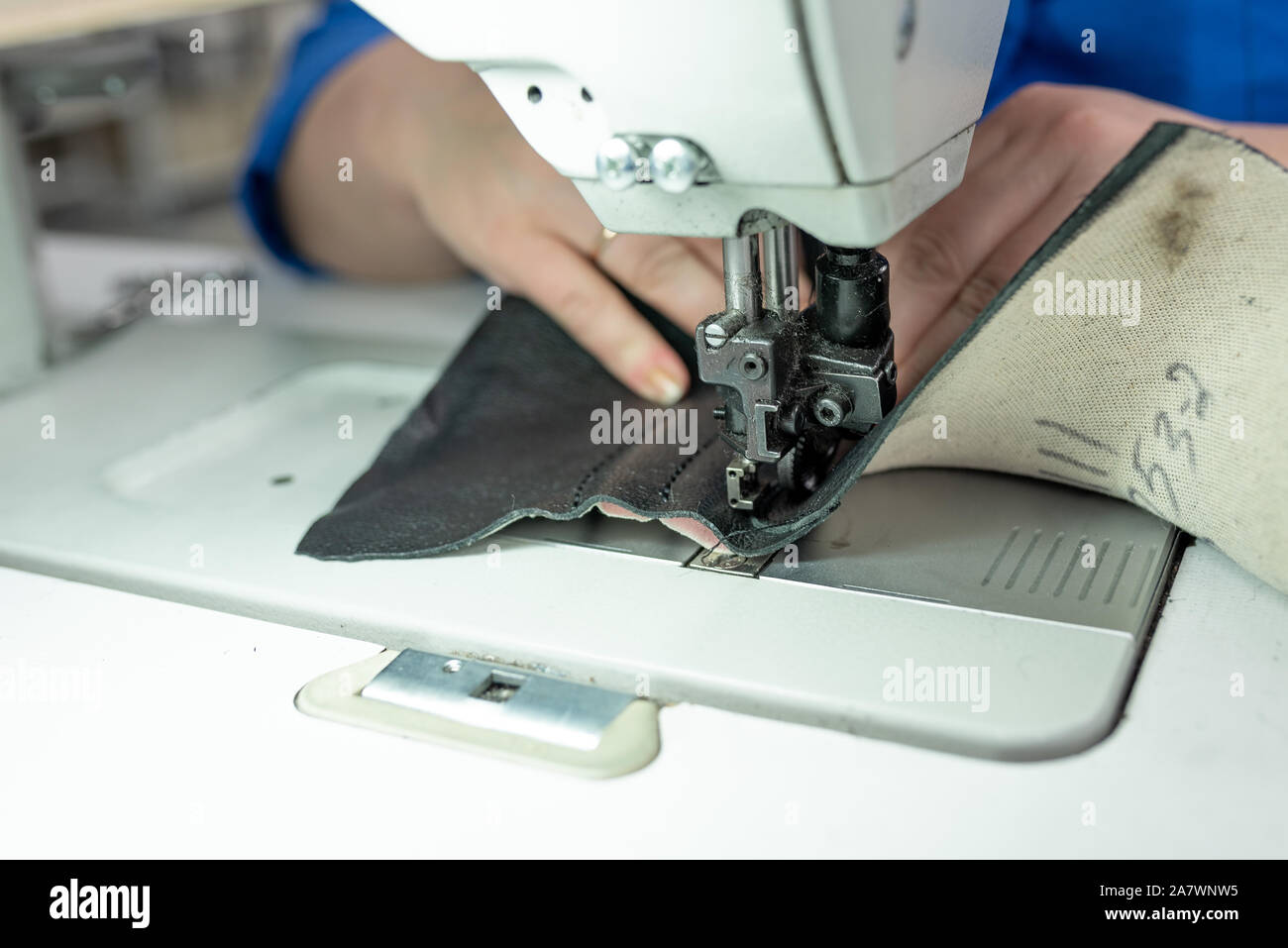 The process of sewing shoes on a sewing machine. Shoe production Stock