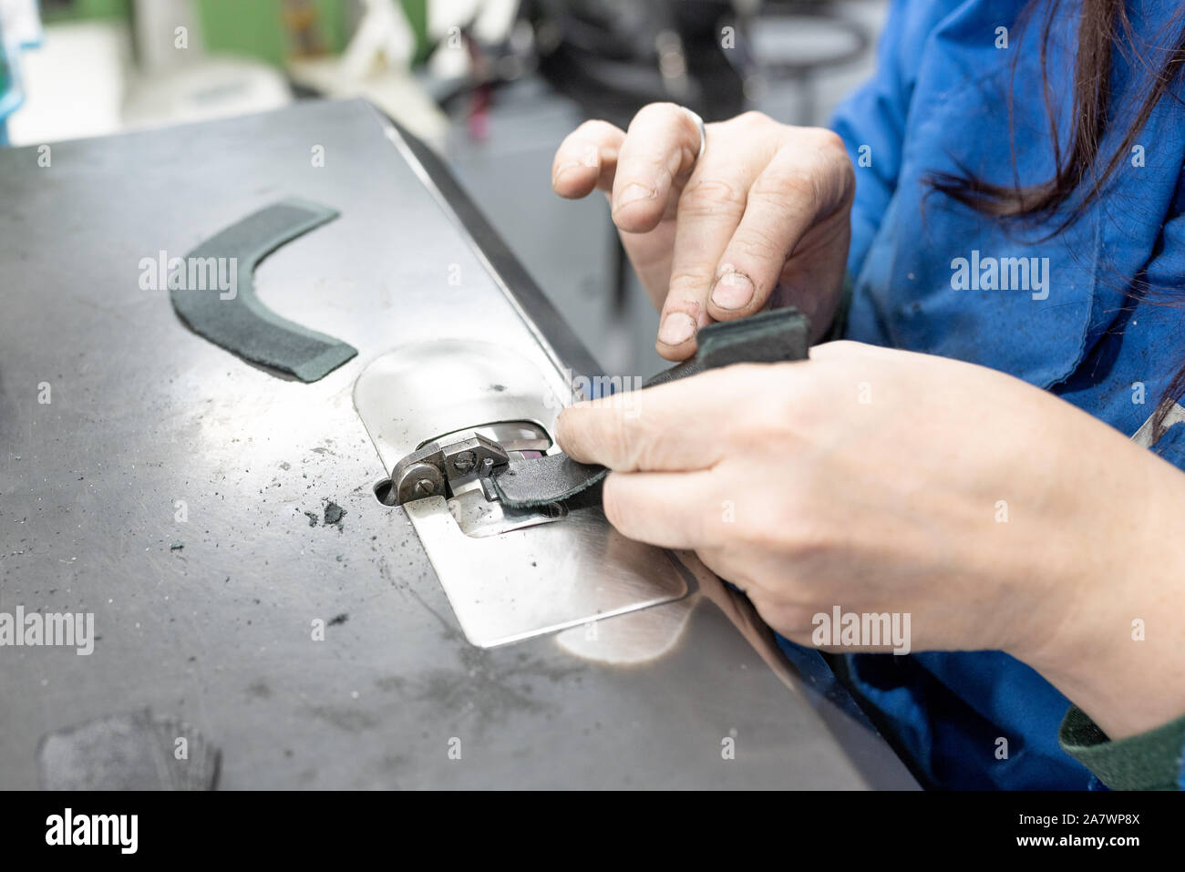 Lowering the edges of parts. Shoe production. Stock Photo