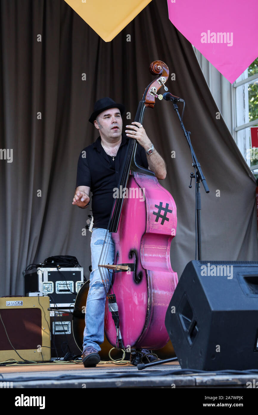 Repa Nurmi playing pink double bass on Espa summer stage at Esplanadi Park in Helsinki, Finland Stock Photo