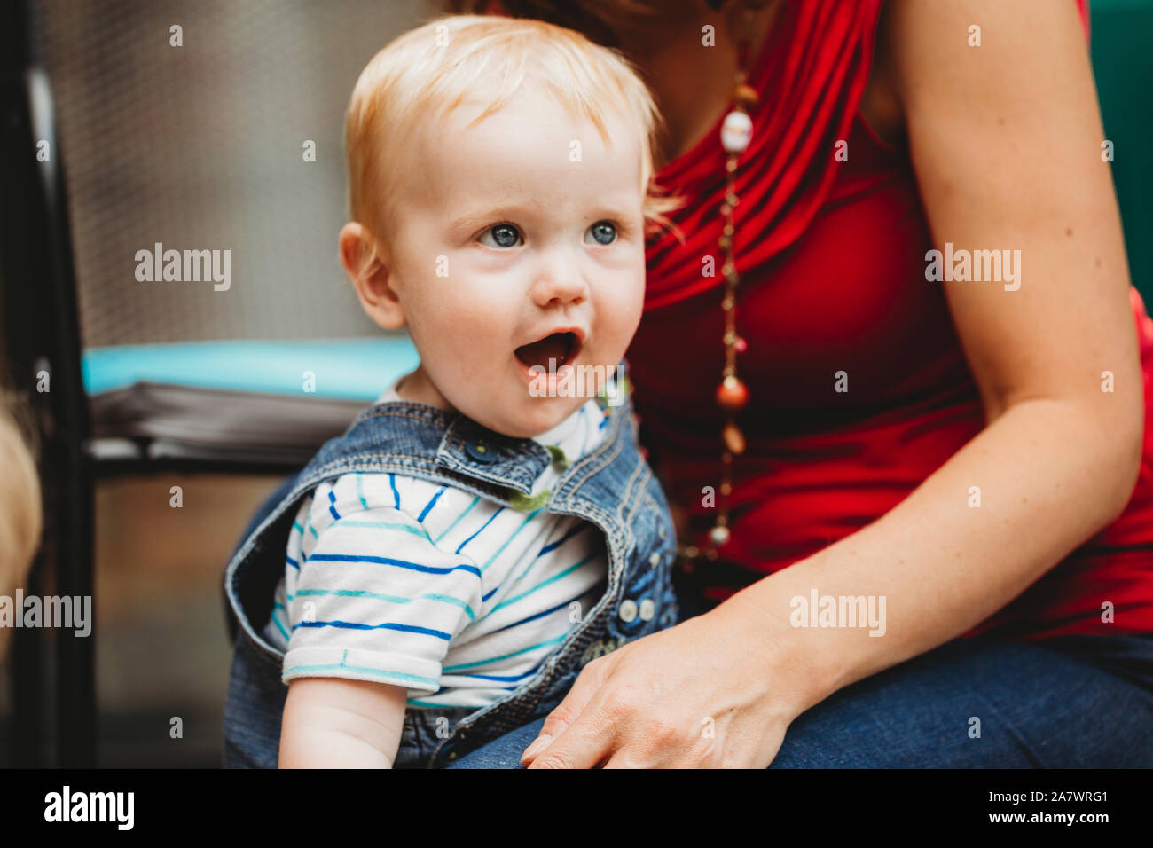 Headshot of cute baby boy standing with mother Stock Photo