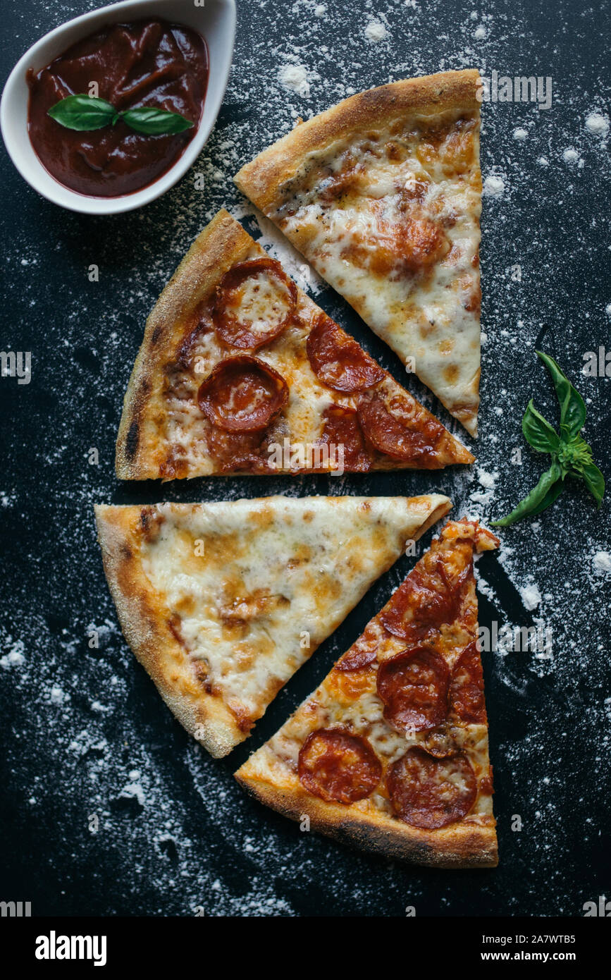 Mix pizza with ketchup on a black background Stock Photo